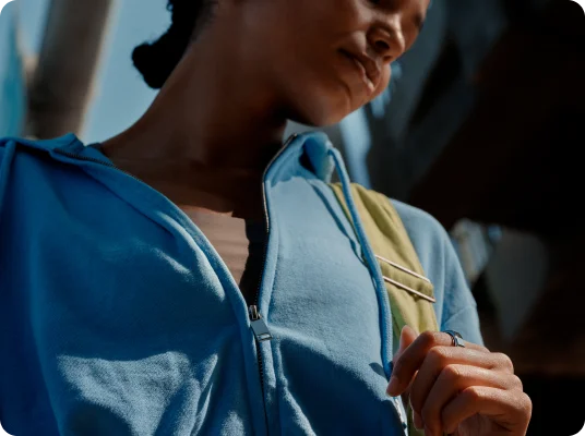 Person with blue hoodie wearing Oura Ring