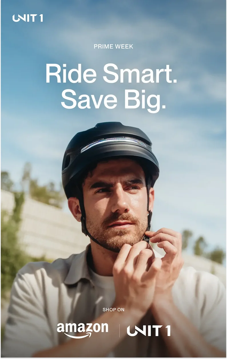 Man fastening a UNIT 1 smart helmet under a clear sky, promoting Prime Week with the message: Ride Smart. Save Big.