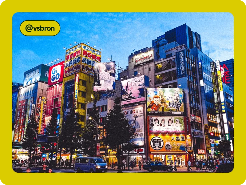 Image Description: A city with billboards on buildings lit up at night.