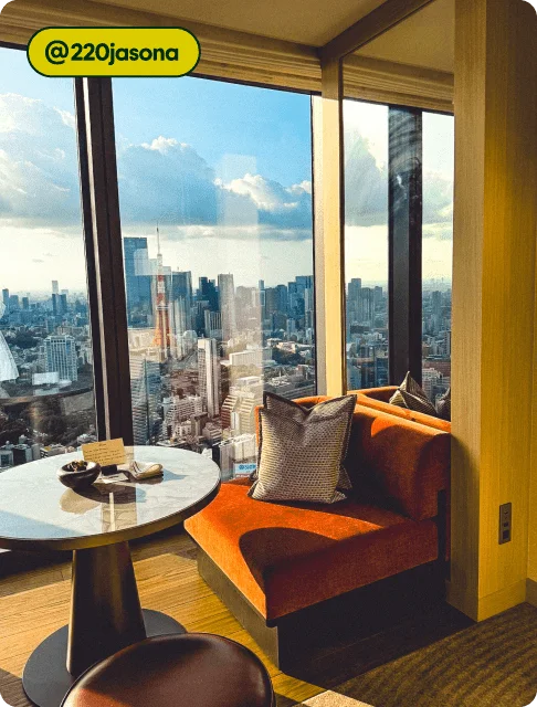 Image Description: A couch and table next to a window overlooking the city.
