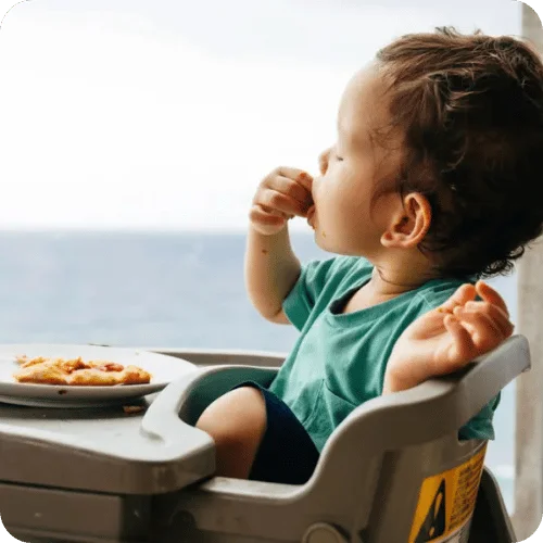 a toddler eating in his high chair a toddler eating in his high chair
