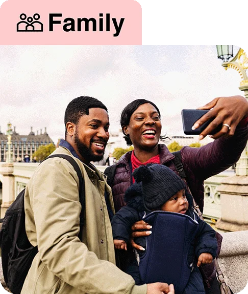 Image description: A family taking a selfie in a city. An icon with three people next to the word “Family” is at the top of the image.