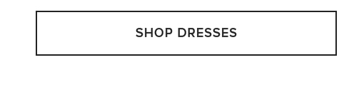 White rectangular button with black outline and "SHOP DRESSES" text. Click to explore our latest women's fashion dresses.