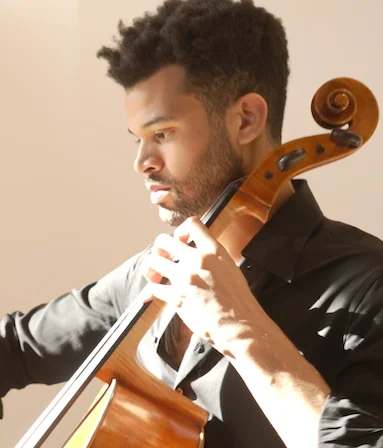 A photograph of a man playing the cello
