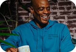 A man wearing a Festival branded blue hoodie.