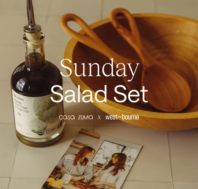 “Sunday Salad Set” featuring a wooden bowl and serving utensils, styled with a bottle of olive oil on a light surface; warm, natural aesthetic by West~bourne.