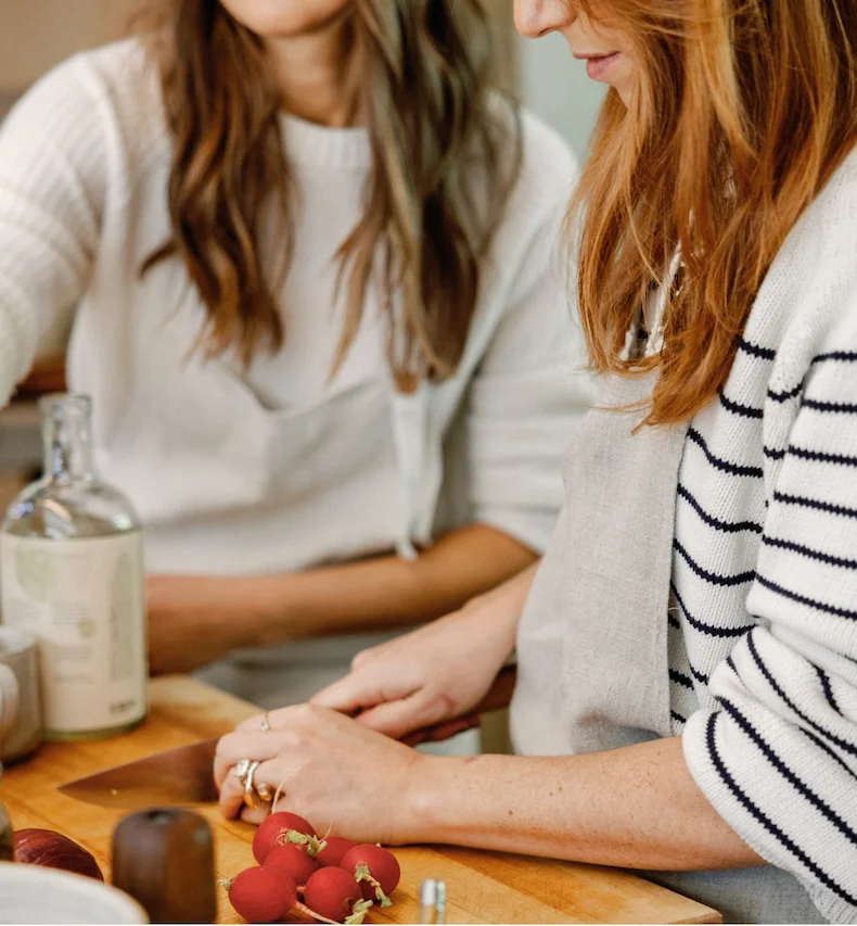 Two women preparing a fresh salad together, part of the “Sunday Salad Set” experience by West~bourne.