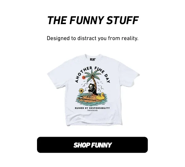 A white t-shirt with a graphic depicting a skeleton sitting under a palm tree on a small island with a rubber ducky, text reads 'ANOTHER FINE DAY' and...