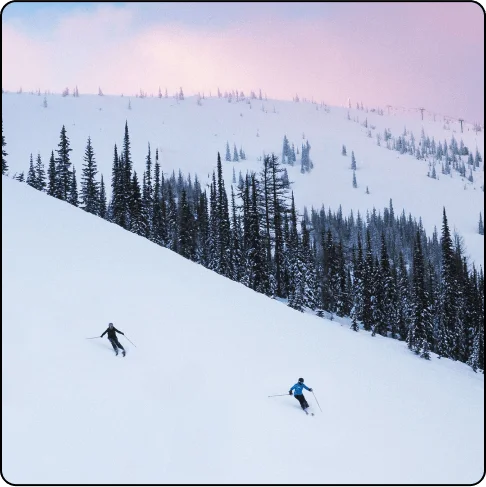 Image Description: Two people skiing down a snowy mountain.