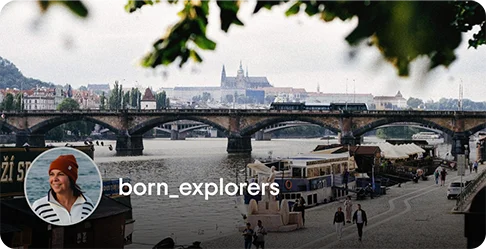 Image Description: A bridge over water in a gothic city. A profile photo of a person wearing a hat and the name born_explorers is on the bottom left corner of the image.