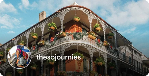 Image Description: A balcony with plants hanging from white ironwork. A profile photo of a person wearing a backpack and the name thesojournies is on the bottom left corner of the image.