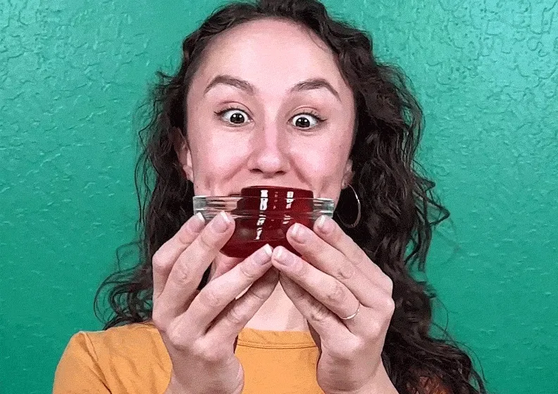 Smiling child holding slime.