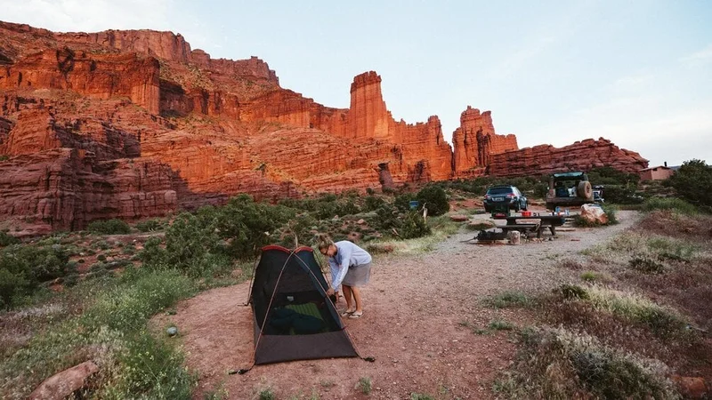 Image description: Woman sets up campsite near Moab, Utah
