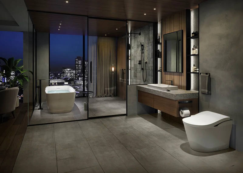 A modern bathroom featuring a NEOREST LS with floor to ceiling windows overlooking a night cityscape