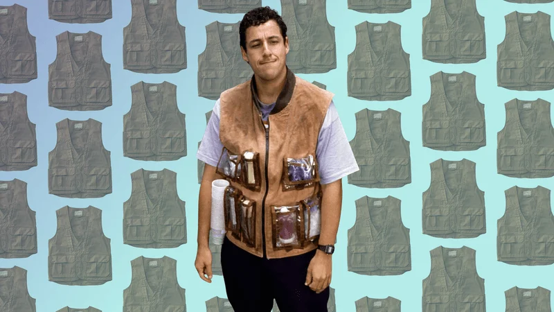 Adam Sandler wearing a utility vest against a repeating backdrop of silhouetted utility vests Adam Sandler wearing a utility vest against a repeating backdrop of silhouetted utility vests