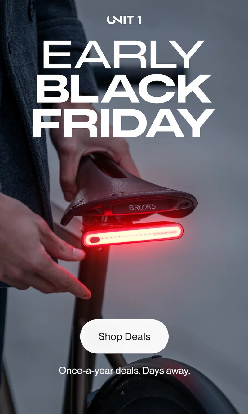 Smart Light mounted under a Brooks saddle glowing red for the Early Black Friday promotion.