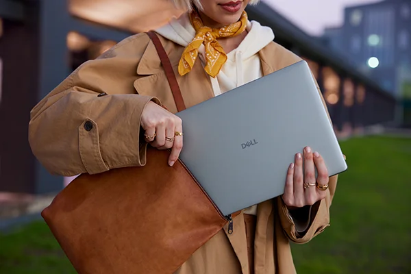 Person using Dell 14 Plus laptop