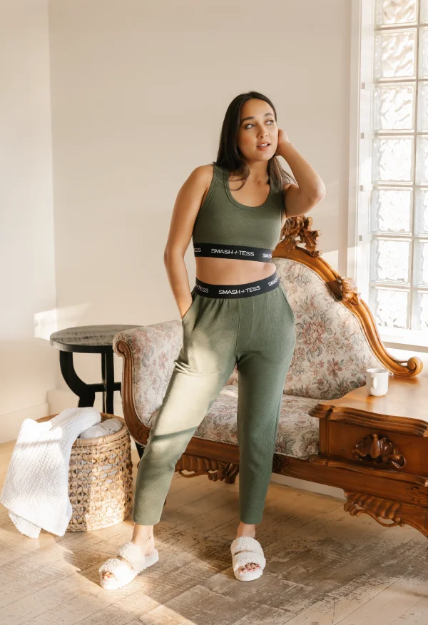 brunette wearing green crop top and jogger