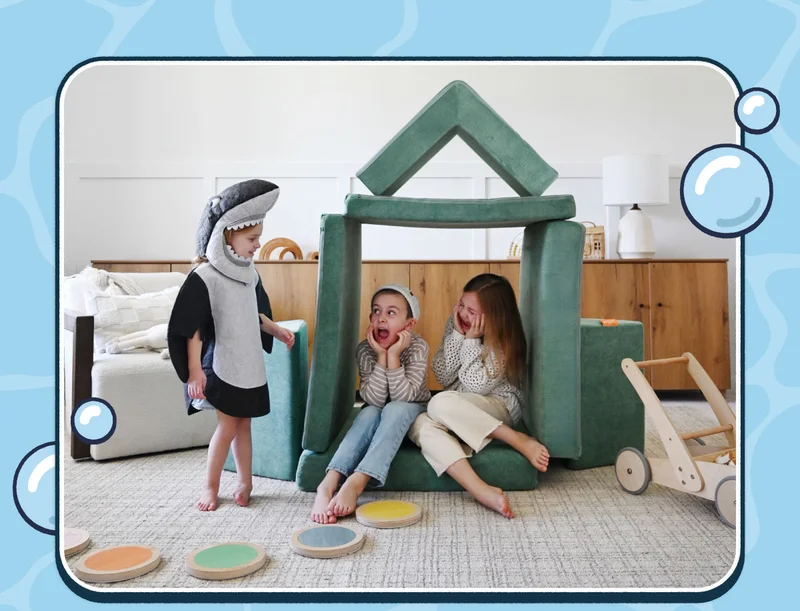 Three children play in a build made from Seamonster Nugget Play Furniture.