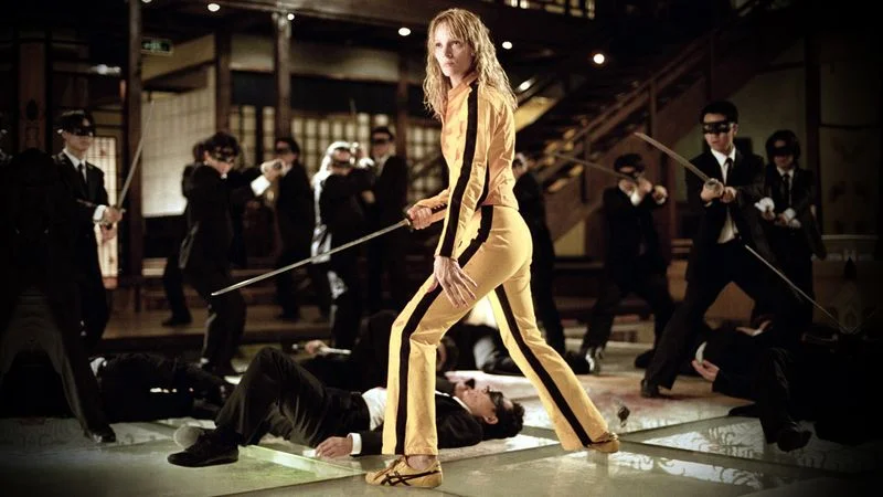 Image may contain: Uma Thurman, Sword, Weapon, Clothing, Footwear, Shoe, Adult, Person, Hat, Wedding, Helmet, and Accessories