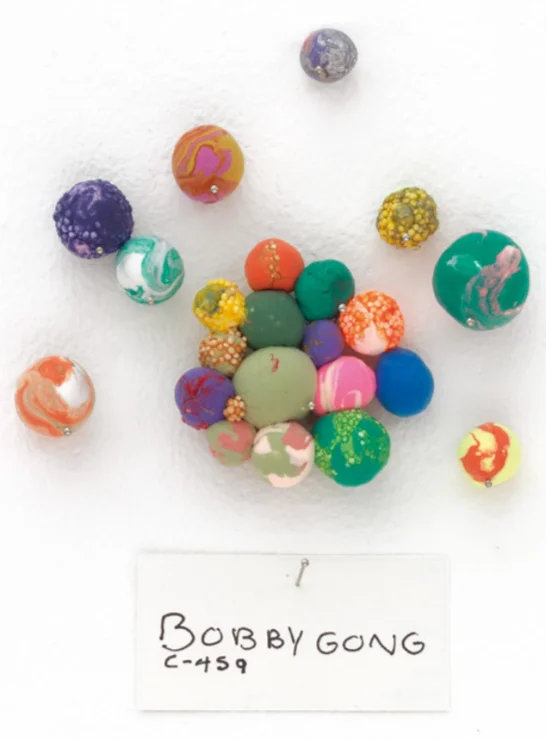 A photograph of colorful clay balls, part of Do Ho Suh’s “Artland”