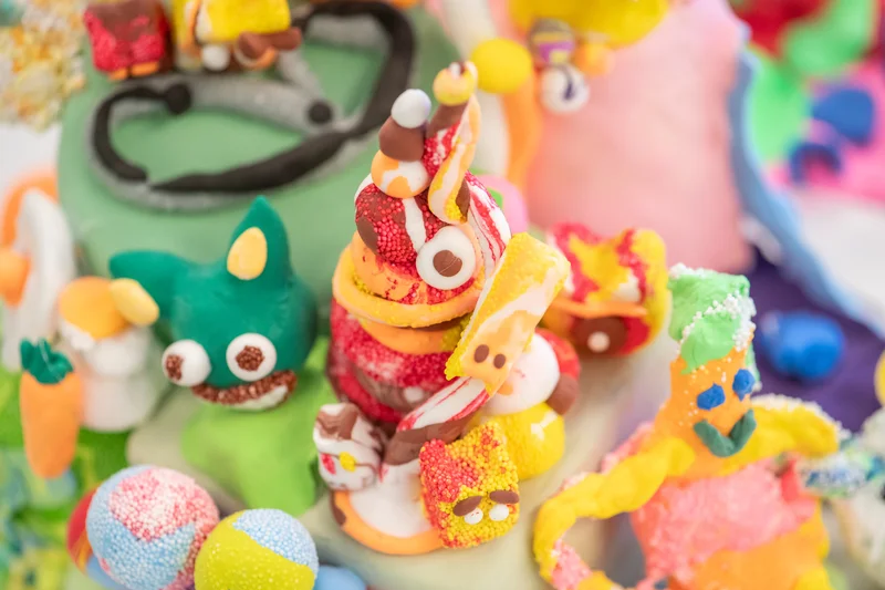 A photograph of colorful clay creatures, part of Do Ho Suh’s “Artland”