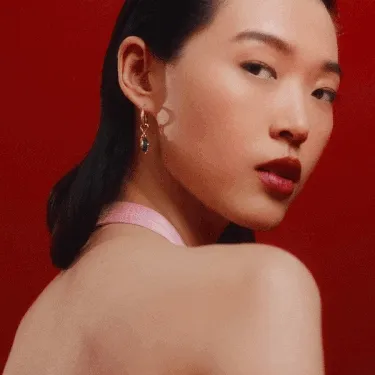 Model wears Pandora earrings with snake charms