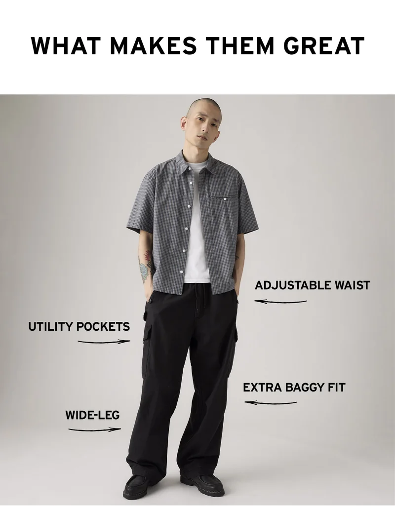 Man wearing black baggy field cargo pants and a short sleeve button up shirt.