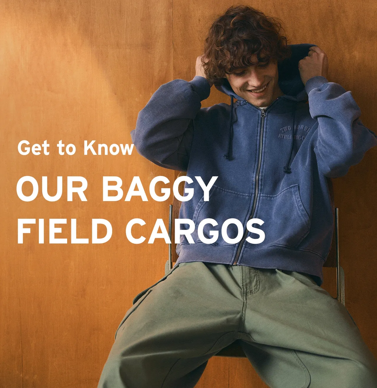 Gif of a man wearing the baggy field cargos and a blue hoodie.