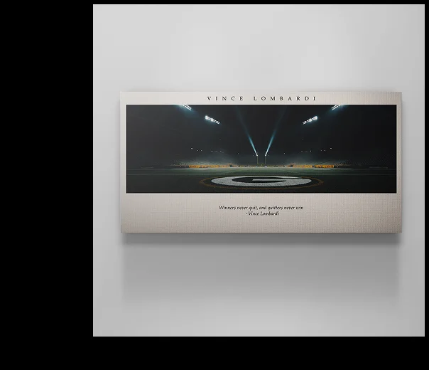 Canvas art depicting a football field at night under stadium lights with the center spotlight illuminating the field. The top text reads “VINCE LOMBARDI,” and the quote beneath says: “Winners never quit, and quitters never win.” — Vince Lombardi. Canvas art depicting a football field at night under stadium lights with the center spotlight illuminating the field. The top text reads “VINCE LOMBARDI,” and the quote beneath says: “Winners never quit, and quitters never win.” — Vince Lombardi.
