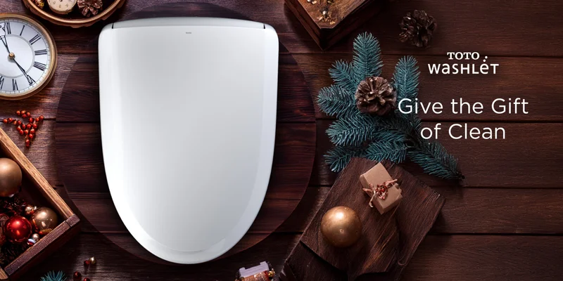 A woman opens a holiday gift to find a TOTO WASHLET inside