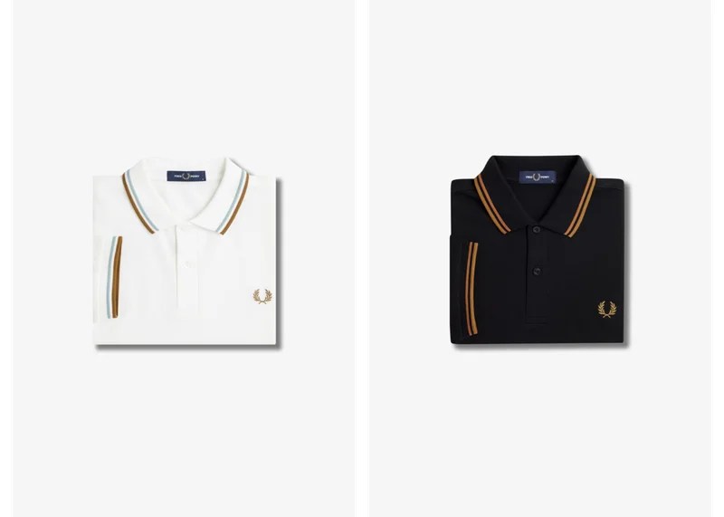 2 folded Fred Perry polo shirts, one white and one black, with coloured tipping