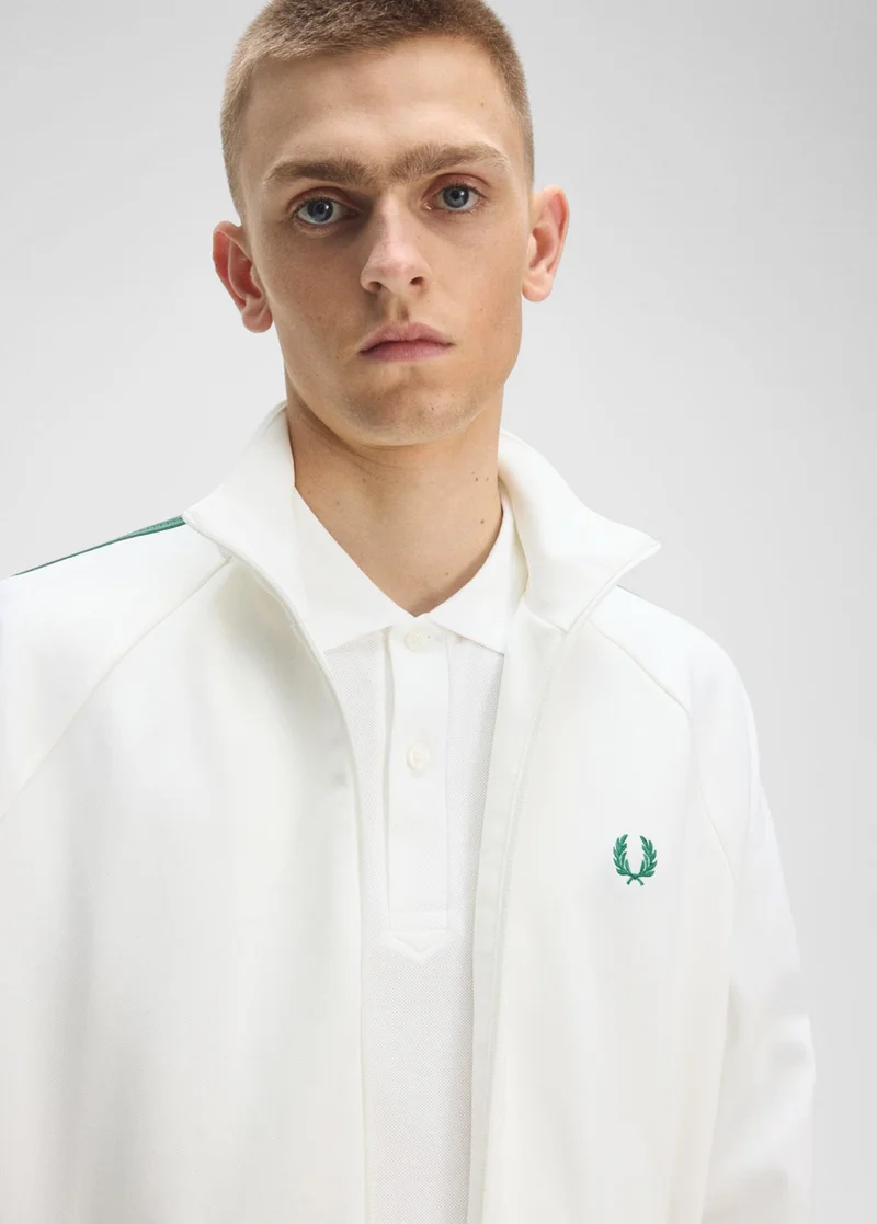 Male model wearing a Fred Perry Mesh Taped Track Jacket in Snow White