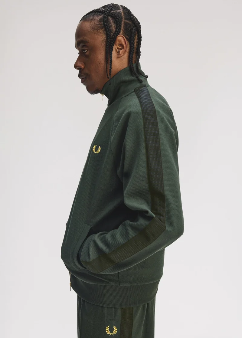 Male model wearing a Fred Perry Dash Taped Track Jacket in Court Green