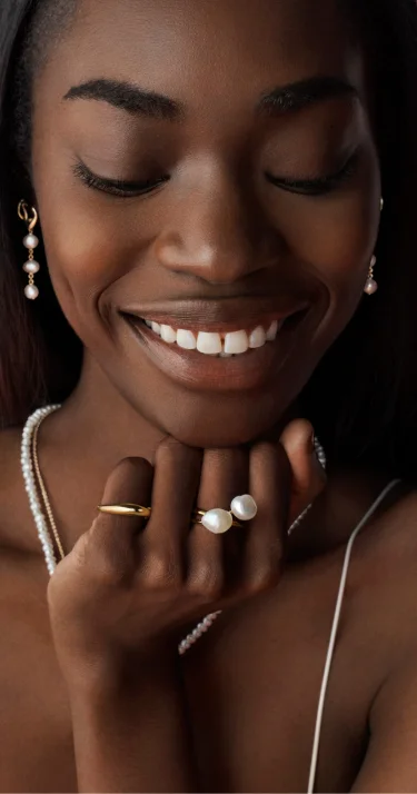 Model wears organic shapes by Pandora.