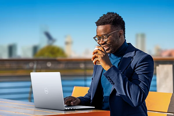Man working outsides with Dell Inspiron 14 5000 Series (Model 5440) non-touch notebook computer, codename Sentry 14.