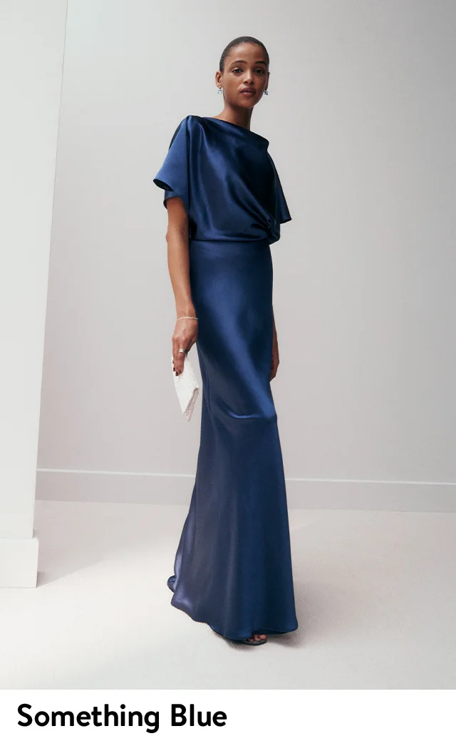 A woman wearing a long blue gown.