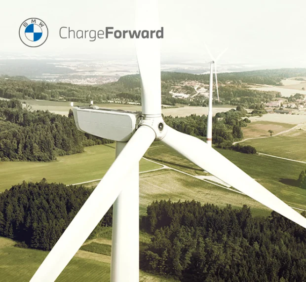 ChargeForward wind turbine with grass fields and trees in the background