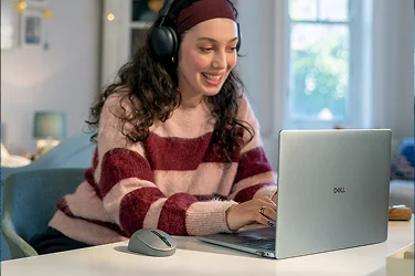 A young person enjoying shopping on a Dell laptop computer.