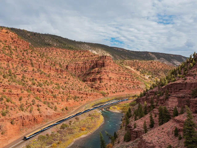 A Canyon Spirit train heads through the Rocky Mountains