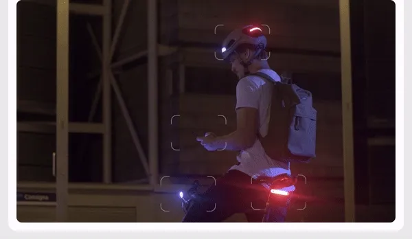 GIF of a man riding his bike at night with his smart cycling ecosystem.