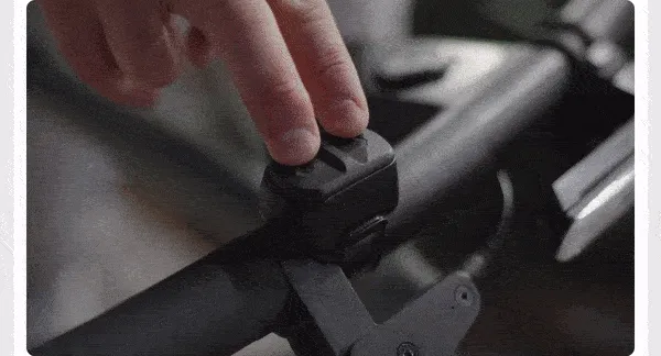 A man turning on his devices in sync with a single tap on the remote power mounted on his bike.