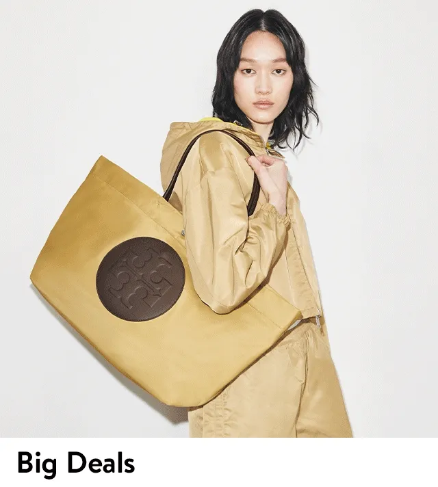 Two women carrying large totes.