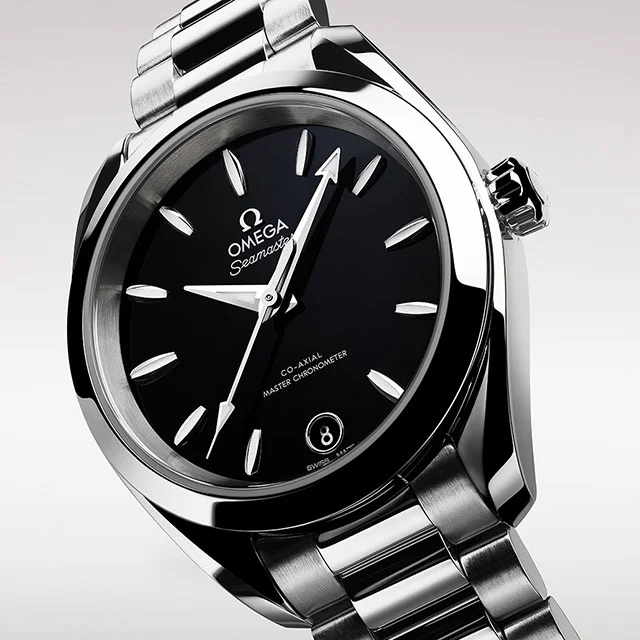 A closeup of a black and silver Omega watch.
