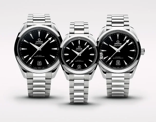 Three black and silver Omega watches in three different sizes.