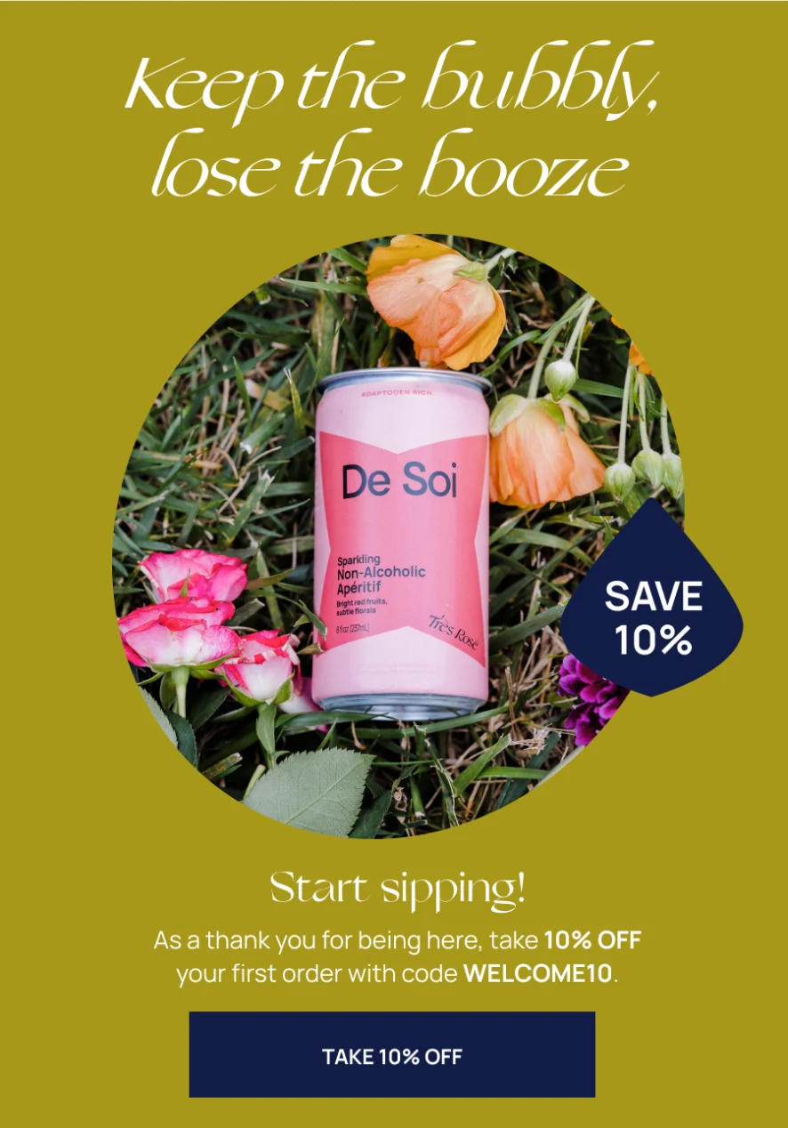 Image containing ad copy: Keep the bubbly, lose the booze. And Champignon Dreams can being poured into a cocktail glass. Blue CTA button: TAKE 10% OFF. Use code WELCOME10