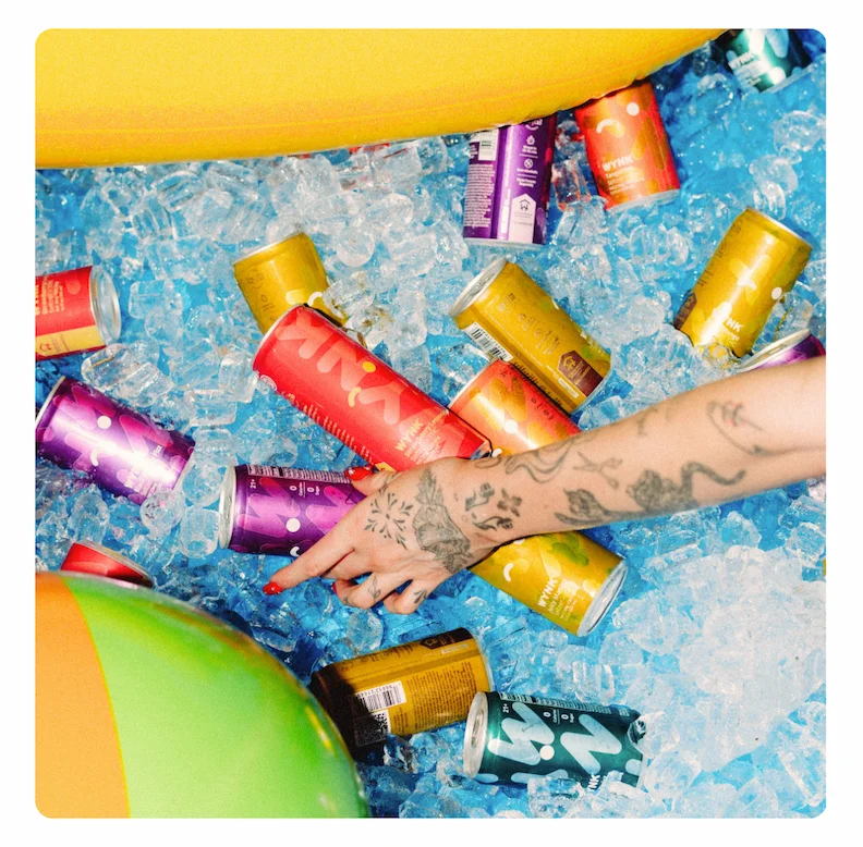 Photo of a pool with floaties, full of ice and cans of Wynk