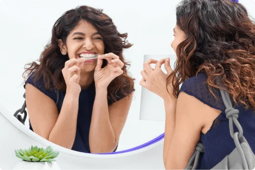 Person applying whitening strip in a mirror