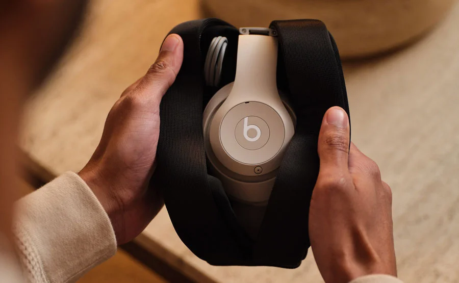Beats Studio Buds + earbuds and case sitting on a wooden table