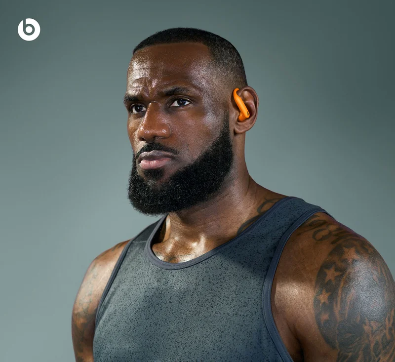 Lebron James wearing Powerbeats Pro 2 in Electric Orange